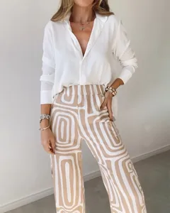 Detail view of women's casual two-piece set with white shirt and geometric print trousers