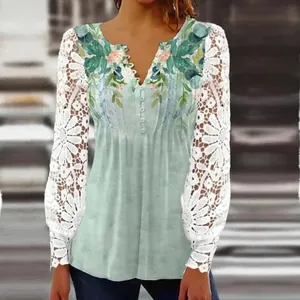 Detail of sage green V-neck top with floral print and white lace flower sleeves.