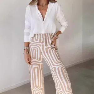 Elegant 2-piece women's set featuring geometric print pants and a classic white shirt
