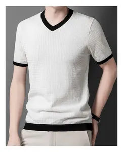 Close-up of men's white hollow knit V-neck sweater with black contrast trim detail.