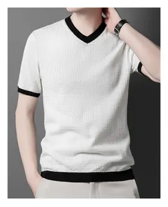 Close-up of men's white textured knit sweater with black contrast V-neck and cuffs