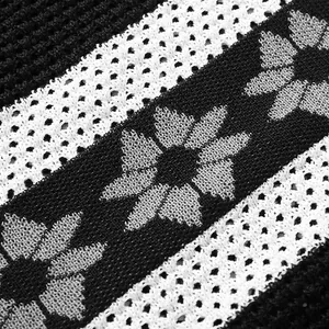 Close-up of breathable black and white hollowed-out knitted men's polo shirt texture