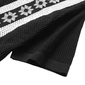 Close-up of men's black 3D breathable hollow knit polo shirt with floral pattern