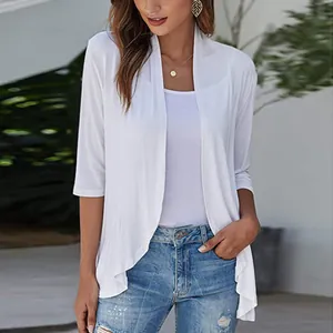 Detail view of a white three-quarter sleeve open-front knit cardigan with ruffles.