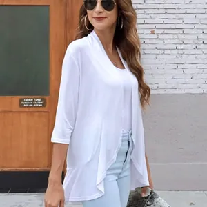 Detail of white three-quarter sleeve cardigan with ruffled hem on female model
