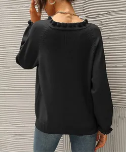 Back view detail of women's black knit sweater with ruffled neckline