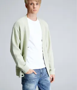 Detailed view of a light sage green V-neck knit cardigan sweater on a male model