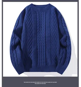 Detail view of a men's navy blue cable-knit sweater with intricate textured patterns.