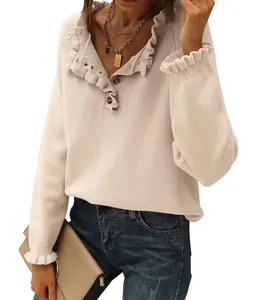 Detail view of women's cream knit sweater with ruffles and button neck