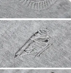 Primo piano dei dettagli strappati e della trama del filato del maglione grigio lavorato