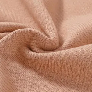 Macro view of high quality dusty pink fine knit material for women's autumn sweater