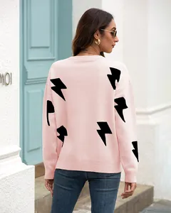 Detailed back view of a pink crewneck knit sweater featuring black lightning bolt patterns