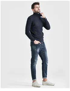 Detailed view of a men's stylish slim fit cable knit turtleneck sweater in dark blue
