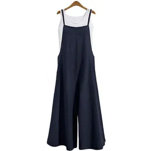 Detail view of women's navy blue loose wide-leg jumpsuit with white tank top set