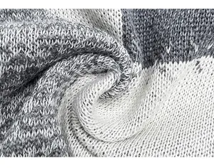 Macro detail view of the grey and white soft knitted fabric showing delicate texture
