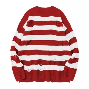 Loose red and white striped distressed knit sweater with crew neck and ripped details
