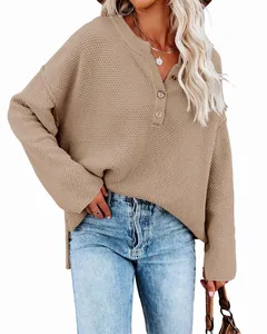 Macro detail of a khaki oversized knitted sweater featuring a front buttoned collar design
