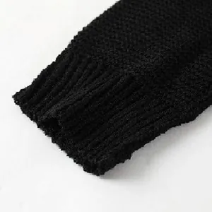 Dettaglio ravvicinato del polsino a coste e della trama a maglia di questo maglione nero