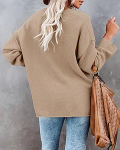 Back view of a casual oversized khaki knitted sweater for women against grey background