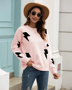Detail view of a pink long-sleeved jacquard knit sweater with lightning bolt patterns