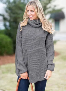 Detail shot of a grey oversized turtleneck knit sweater with textured long sleeves