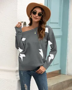 Close-up of women's grey knitted sweater featuring white lightning bolt jacquard details
