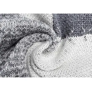 Detailed macro view of high-quality grey and white marled knit fabric for men's sweater