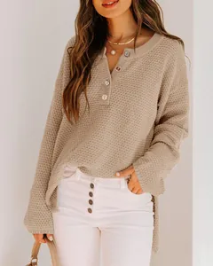 Detail view of casual beige waffle knit sweater with buttoned henley neckline for women.