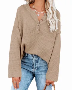 Close-up view of a khaki waffle knit sweater with a four-button henley neckline detail