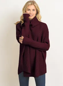 Detailed view of burgundy oversized turtleneck sweater with textured knit pattern