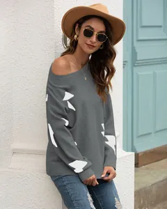 Stylish grey long-sleeved jacquard knit sweater for women styled with a hat and jeans