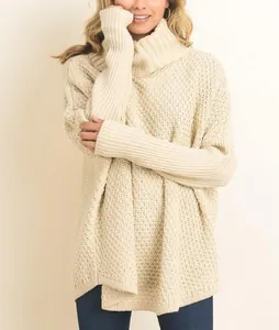 Cozy cream-colored chunky knit turtleneck sweater with ribbed cuffs and loose fit