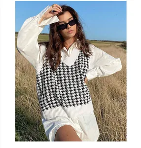 Detail showing the black and white houndstooth sweater vest paired with a shirt.