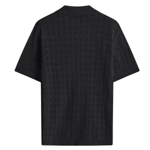 Back view of a black men's knitted short sleeve polo shirt with textured mesh pattern