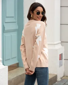 Detailed back view of a beige women's knit sweater with white lightning bolt sleeve patterns.