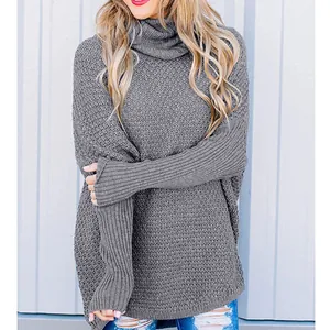 Cozy women's grey chunky knit turtleneck sweater in a loose casual pullover style