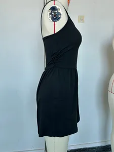 Side view detail of a black sleeveless strapless romper jumpsuit on a white tailor mannequin