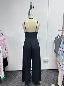 Rear view of a stylish black spaghetti strap wide-leg jumpsuit displayed on a mannequin.