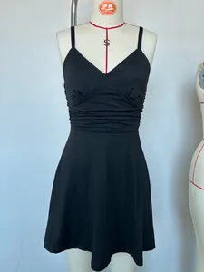 Close-up front view of a minimalist black V-neck slip dress displayed on a professional mannequin