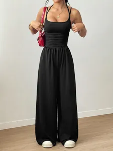 Detailed view of a black summer halter jumpsuit with wide leg design and ruffled waist