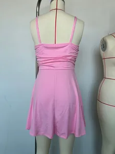Detailed back view of a pink minimalist spaghetti strap summer dress on a mannequin