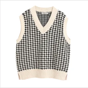 Classic black and white houndstooth knit vest with V-neck and side slits for women