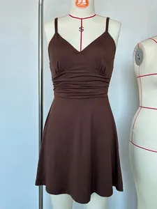 Elegant brown V-neck slip dress with ruched waist detail displayed on a tailoring mannequin.