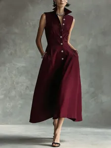 Elegant burgundy sleeveless midi dress with high collar and buttons, fashion detail view.