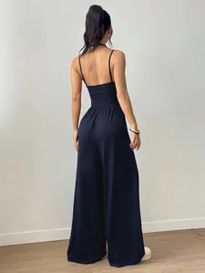 Elegant back view of a navy blue wide-leg summer jumpsuit with thin spaghetti straps