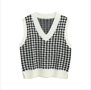 Classic black and white houndstooth knitted sweater vest with a V-neck and ribbed trim