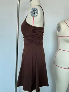 Side view detail of a brown sleeveless dress with elegant ruching design on the waist