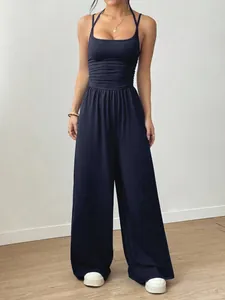 Elegant navy blue sleeveless jumpsuit with ruched waist and flowing wide legs
