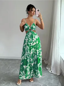 Detailed view of a green floral print maxi dress with side cut-outs and ring detail.