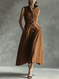Close-up detail view of a brown sleeveless button-down midi dress featuring a chic stand-up collar